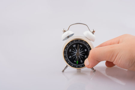 Child holding a compass on the alarm clock
