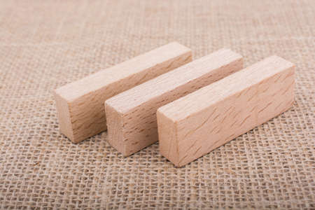 Wooden domino  on a  linen canvas backgroundの写真素材