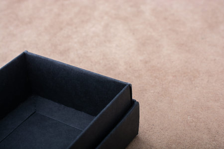 Gift box of black color  on brown background
