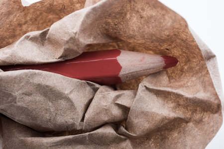 Color pencil wrapped in a piece of paper