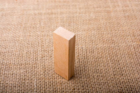 Wooden domino  on a  linen canvas backgroundの写真素材