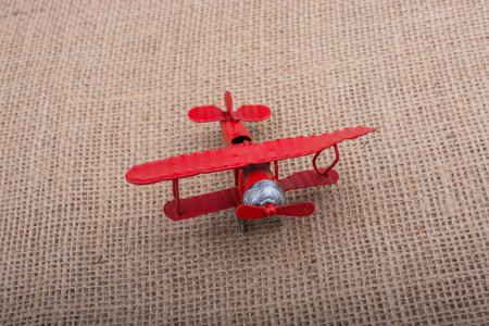 Toy airplane on a linen canvas background