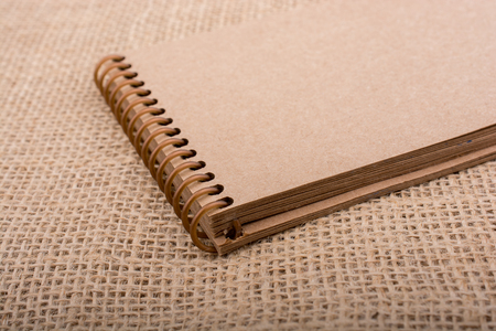 brown color notebook placed on a canvas backgroundの写真素材