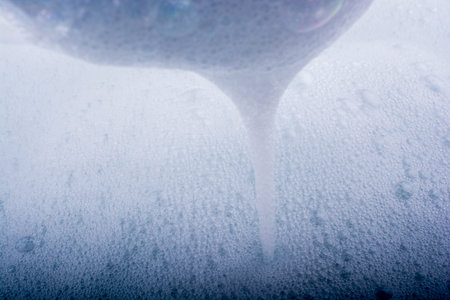 Pure water covered with foam of shampooの写真素材