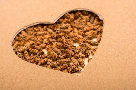 Heart shape hole on paper on the linen canvasの写真素材