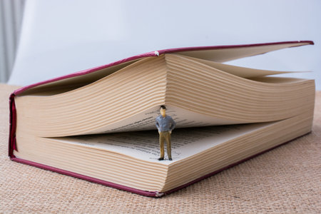 Man figurine standing inside the pages of the  book