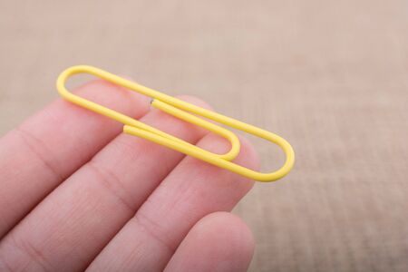 Colorful clip in hnad on a linen canvasのeditorial素材