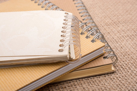 brown color spiral notebook placed on a canvas backgroundの写真素材