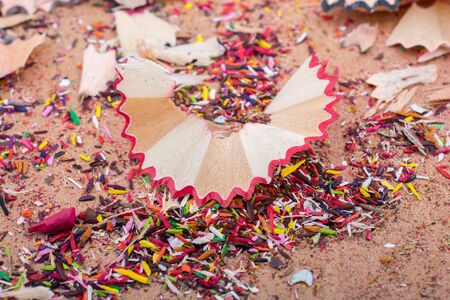 Colorful pencil shavings on a brown backgroundの写真素材