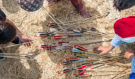 Hand holding old style  wooden arrowsの写真素材