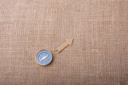 Compass and  paper arrow on a canvas backgroundの写真素材