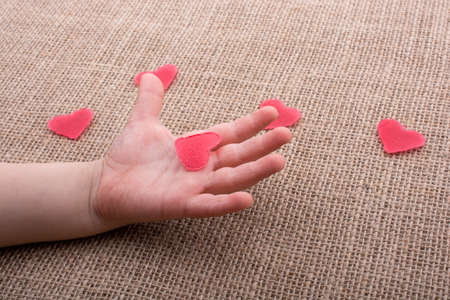 Heart shaped object  in the hand of a toddlerの写真素材