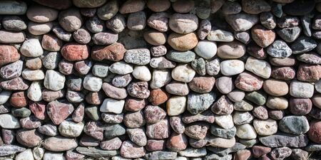 Wall made of the same type and same color of stonesの写真素材