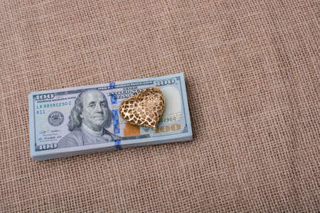 heart icon bundle of US dollar placed on a linen canvasの写真素材