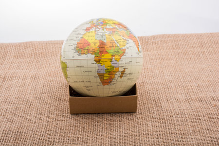 Globe with a telephone booth on canvas background