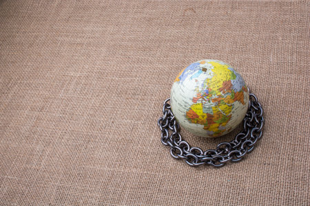 Chain around globe placed on canvas background