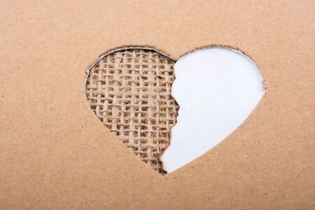 Paper and canvas  seen through heart shape hole out of cardboardの写真素材