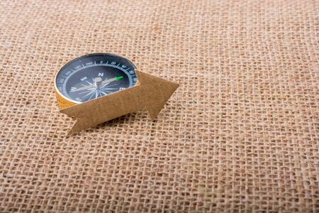 Compass and  paper arrow on a canvas backgroundの写真素材