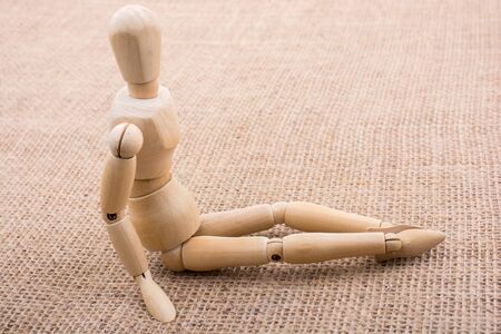 Wooden dolls of a man posing on canvasの写真素材