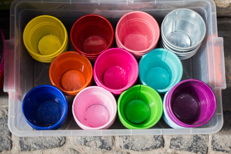 Little set of buckets of various colors in a market placeの写真素材