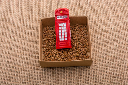 Red color phone booth in a box on a canvas backgroundの写真素材
