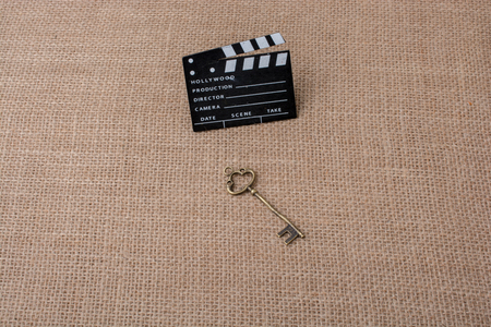 Movie clapper and retro key on canvas backgroundの写真素材
