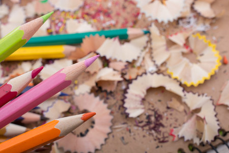 Color Pencils over a notebook with pencil shavings