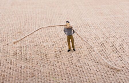 Figurine man with a rope on the neckの写真素材