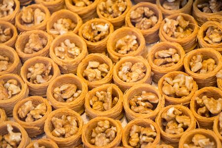 Nut stuffed dessert of mini size cuisine in handの写真素材