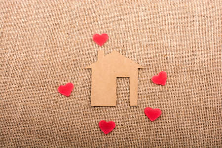 Heart shape around the  paper house with a canvas backgroundの写真素材