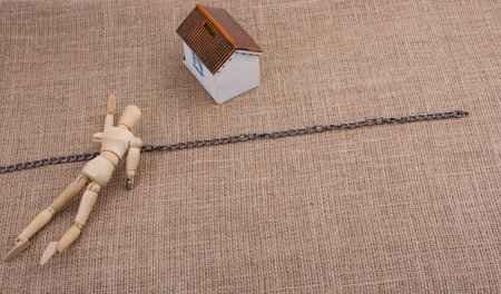 Man figurine and a Model house beyond the chain line on a canvas