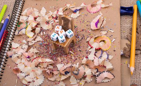 Colorful letter cubes on chair in pencil trashの写真素材