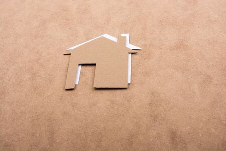 Little paper houses on a brown backgroundの写真素材