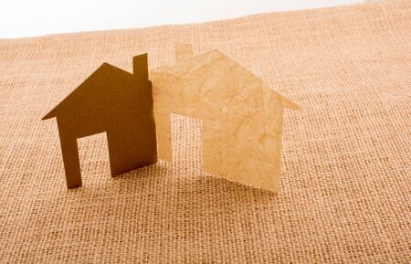 Little house shape cut out of paper on a canvas backgroundの写真素材