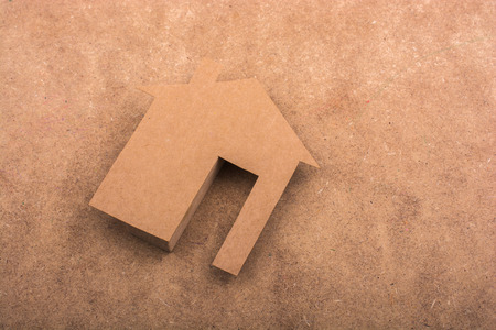 Little paper houses on a brown backgroundの写真素材