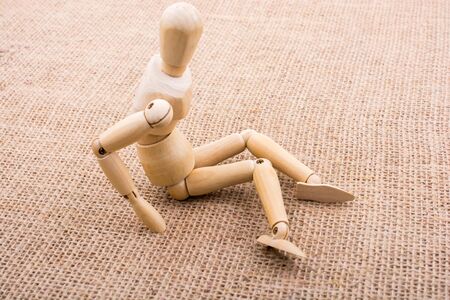 Wooden dolls of a man posing on canvasの写真素材