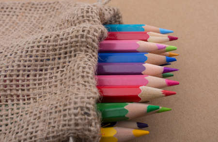 Color Pencils in a linen sack on canvasの写真素材