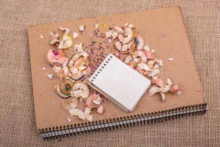 Spiral notebooks amid some colorful pencil trashの写真素材