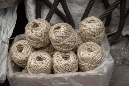 Plenty of spools or rolls of brown color linen string