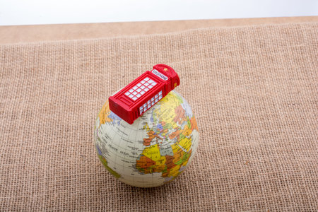 Globe with a telephone booth on canvas backgroundの写真素材