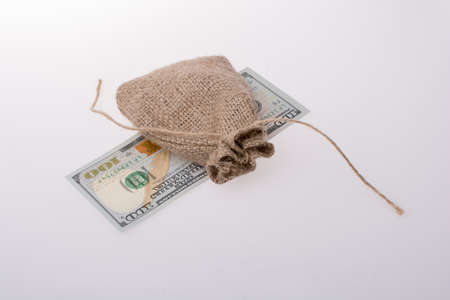 Banknote of US dollar placed under a linen sackの写真素材