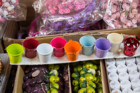 Little set of buckets of various colors in a market placeの写真素材