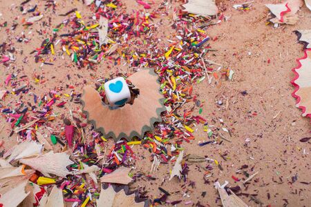 Heart shaped object amid pencil shavingsの写真素材