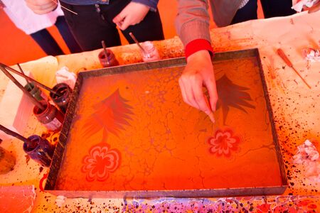 Hand drawing with stick stained inks on water surfaceの写真素材