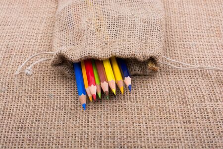 Color Pencils in a linen sack on canvasの写真素材