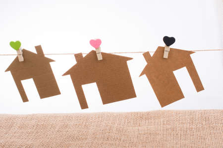 Little paper houses attached to a string with a heart clipの写真素材