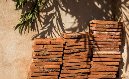 Old grunge bricks beside the wallの写真素材