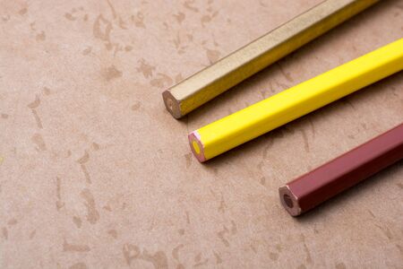 Color Pencils placed on a brown backgroundの写真素材