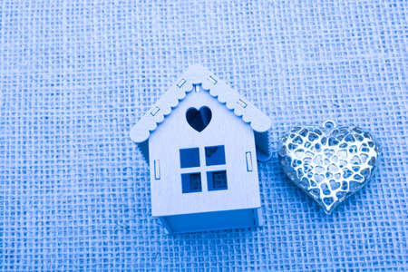 Heart shaped icon and model houses on a brown backgroundの写真素材