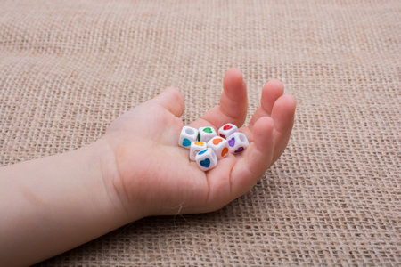 Colorful cubes with a heart in hand on canvasの写真素材